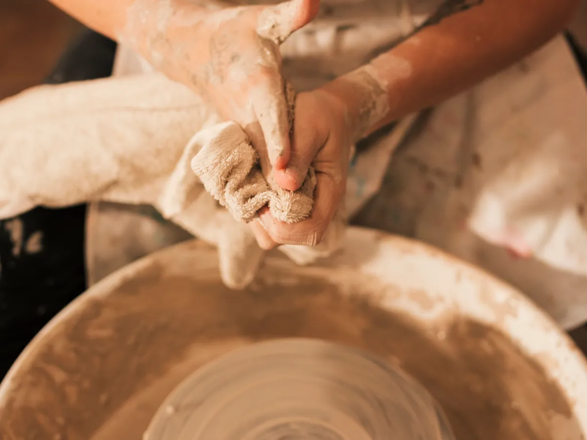 A course owner's hands at the potter's wheel — the work they'd rather be doing than admin